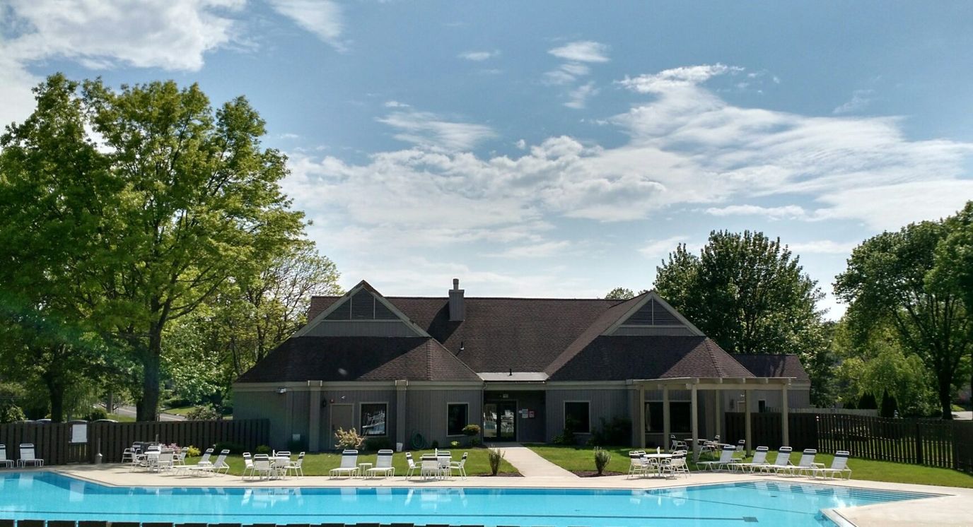 Exterior view of a senior living facility with a pool