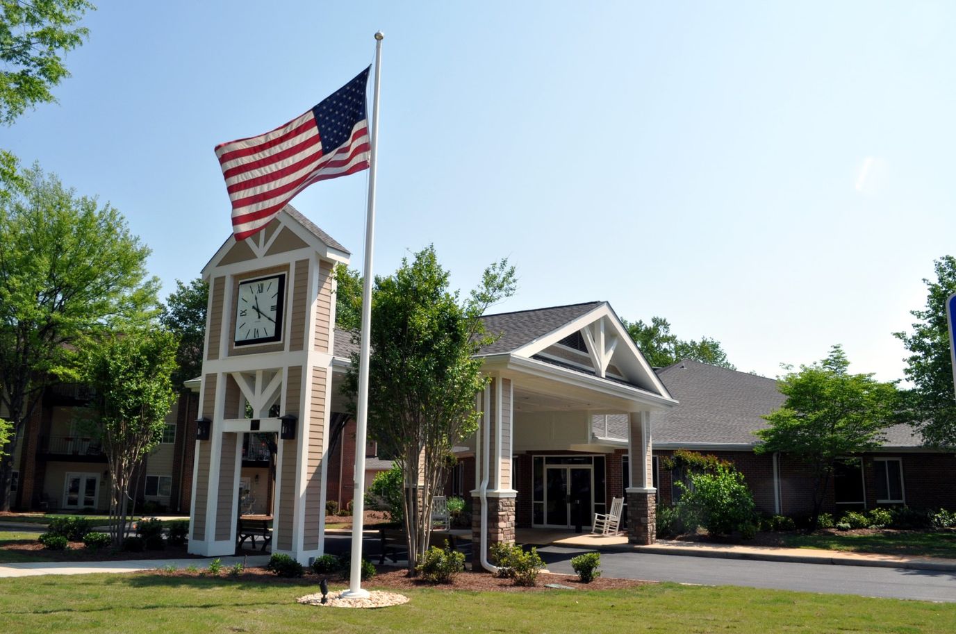 Exterior view of St Mary's Highland Hills Village with flag