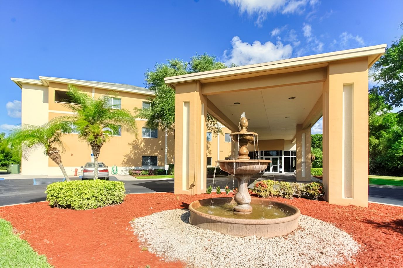 Building exterior with a fountain and landscaping