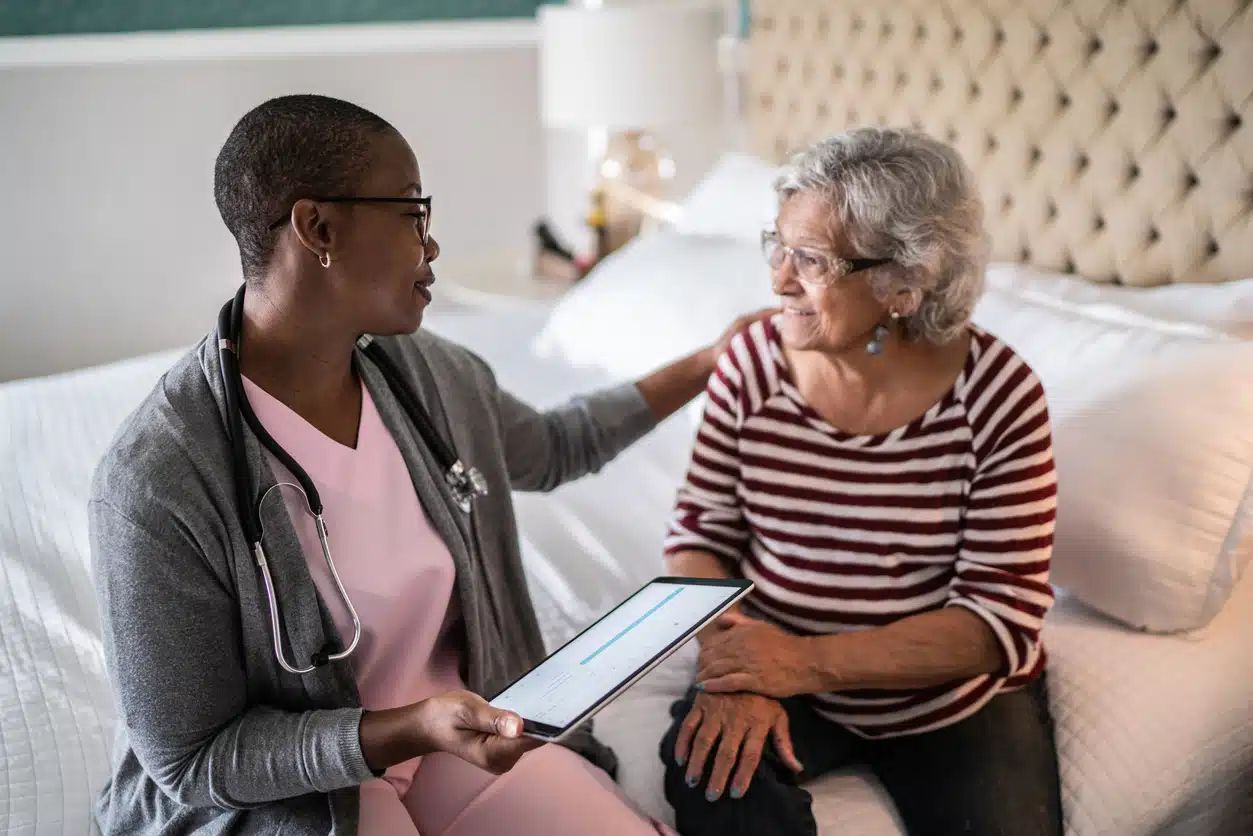 Healthcare professional engaging with a senior resident.