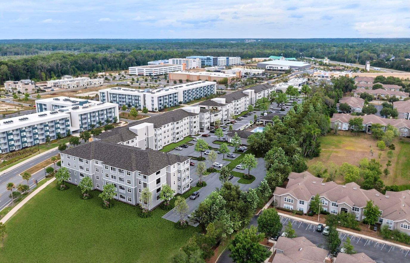 Aerial view of a senior living facility with parking and grounds