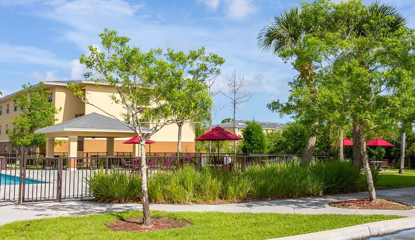 Outdoor pool area with patio and umbrellas