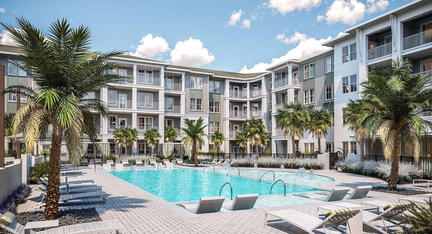 Outdoor pool area with palm trees and lounge chairs