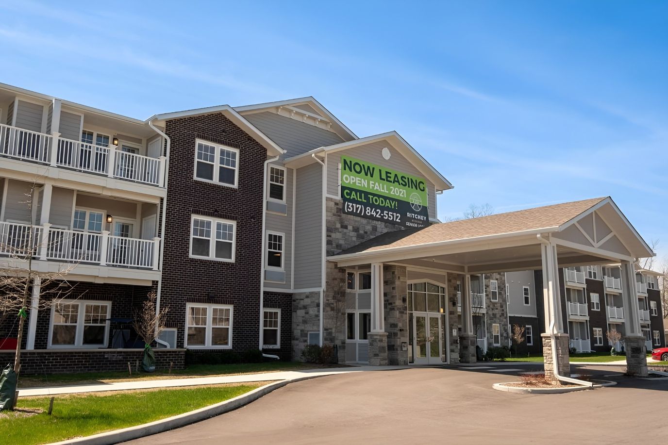 Exterior view of a senior living facility with leasing sign