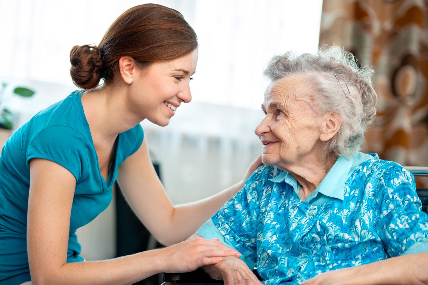 A caregiver interacting with a senior resident