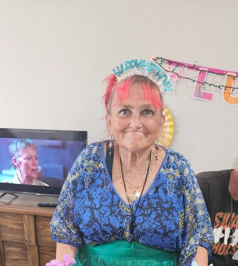 Angels Of Care Boarding Homes, senior care in Tucson, AZ — Elderly woman wearing a festive headband while celebrating