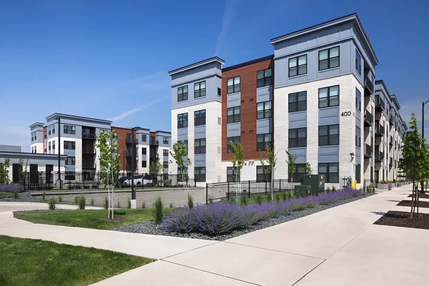 Exterior view of a senior living facility with gardens