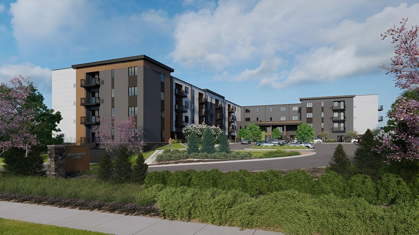 Exterior view of Aura Independent Living facility surrounded by greenery