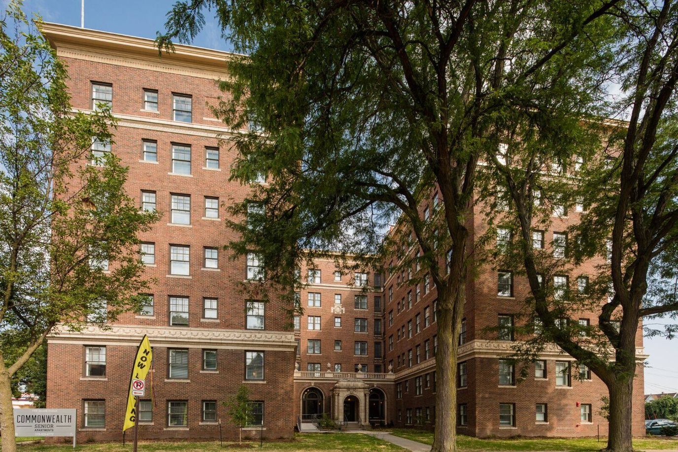Exterior view of Commonwealth Senior Apartments surrounded by trees