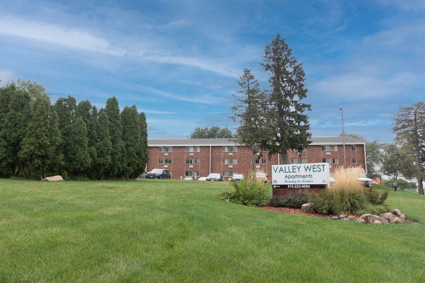 Exterior view of Valley West Apartments with green lawn
