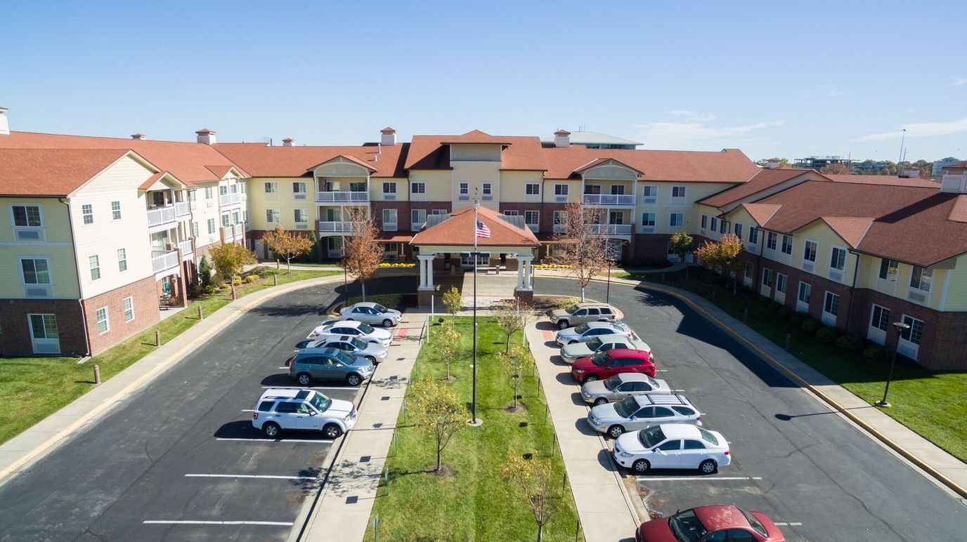 Aerial view of senior living facility with landscaped grounds