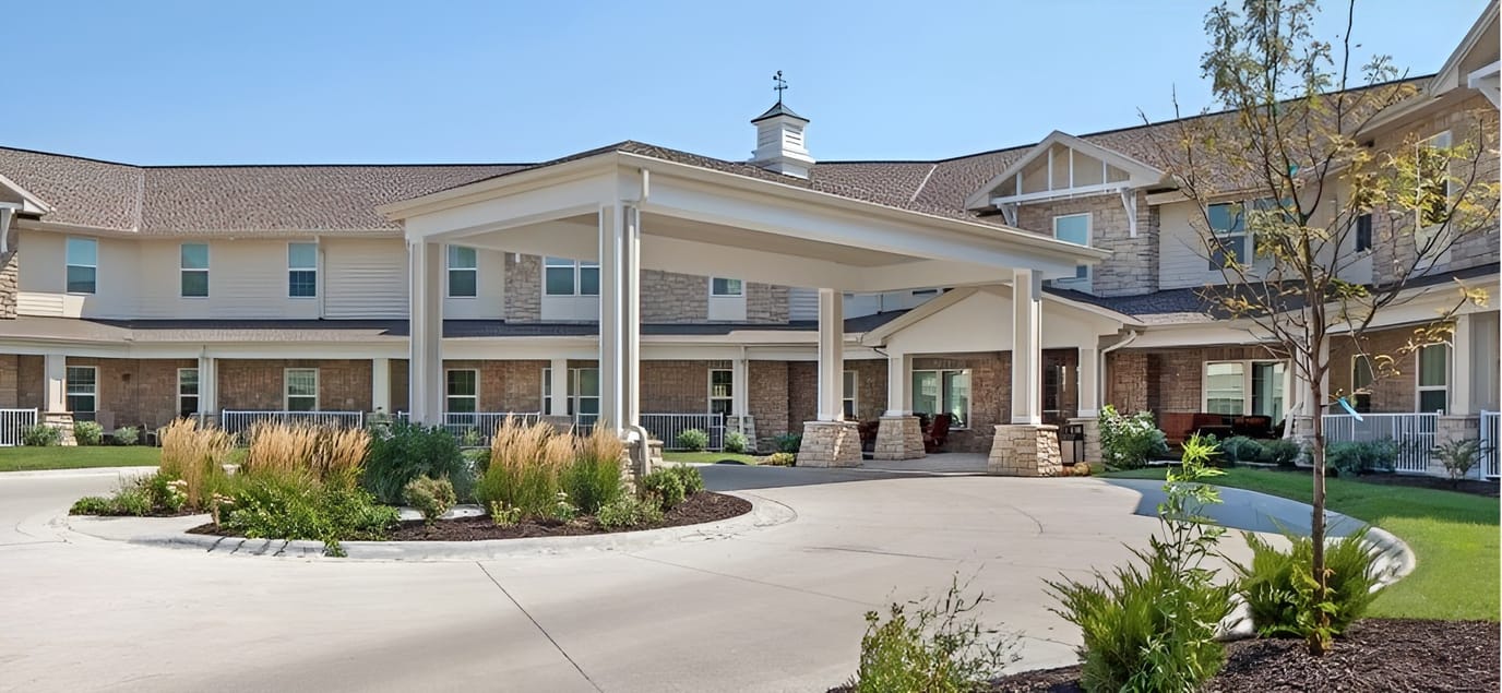 Exterior view of the facility entrance with garden landscaping