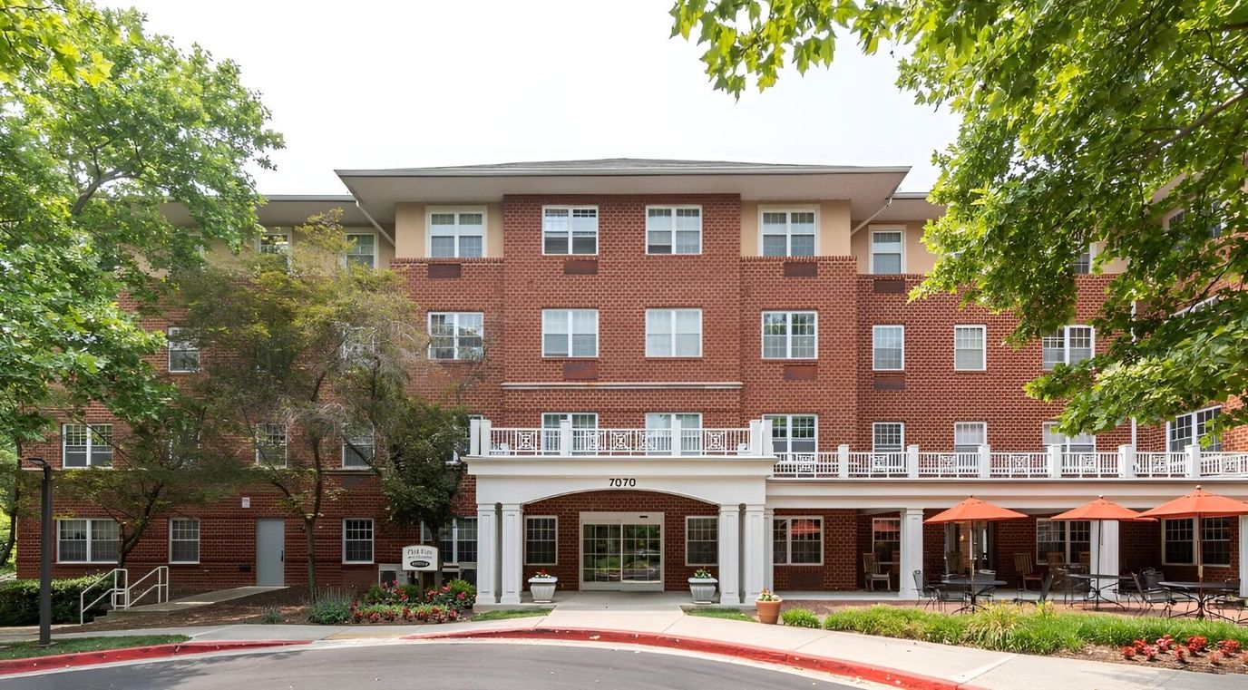 Exterior view of senior living facility with patio area