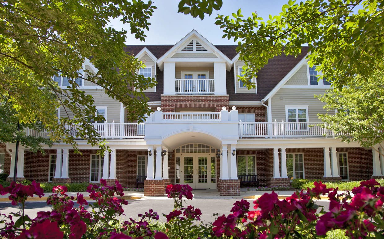 Exterior view of Willows Senior Community surrounded by flowers