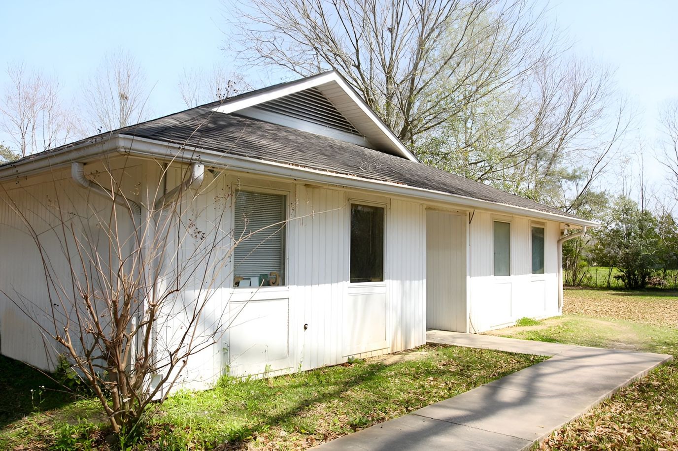 Exterior view of a small building in a green space