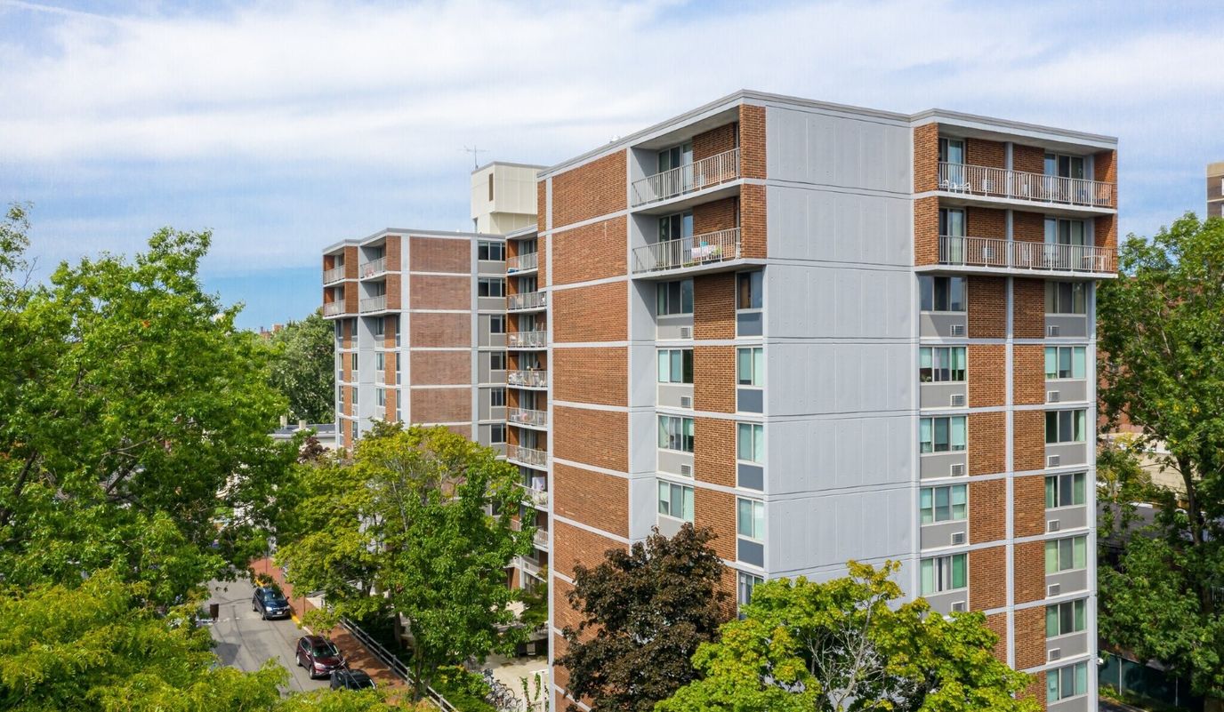 Exterior view of a senior living facility surrounded by trees