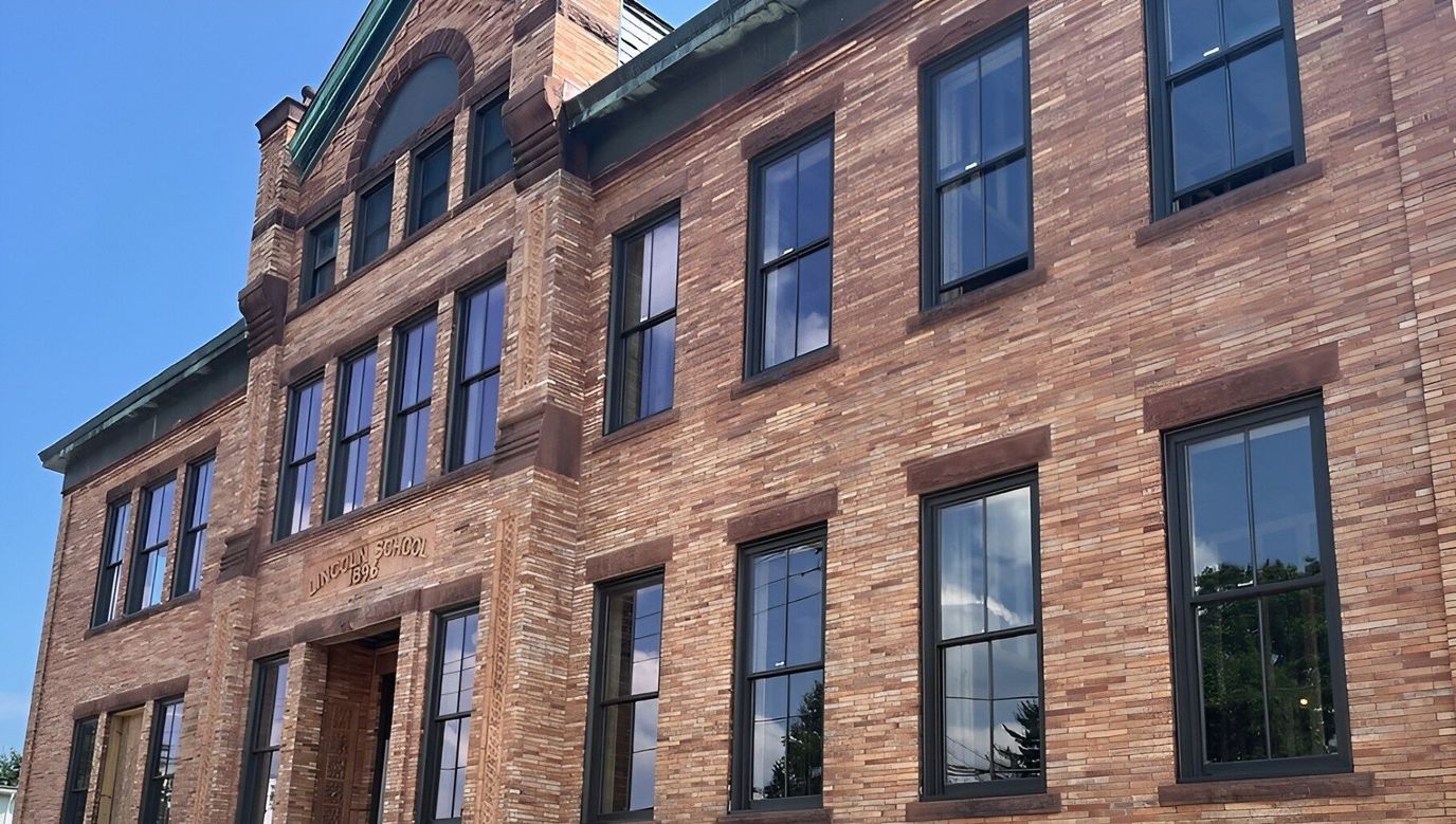 Exterior view of a brick building with large windows