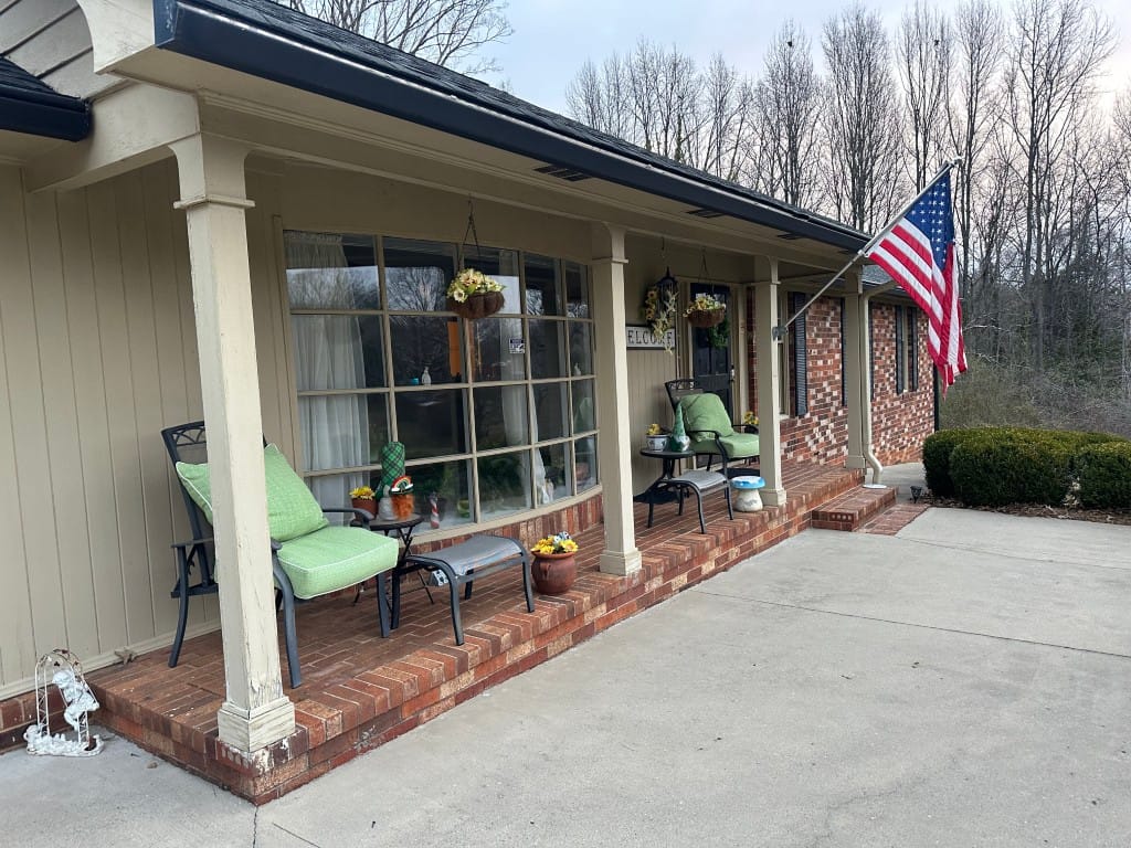 Front porch of a senior living facility with American flag