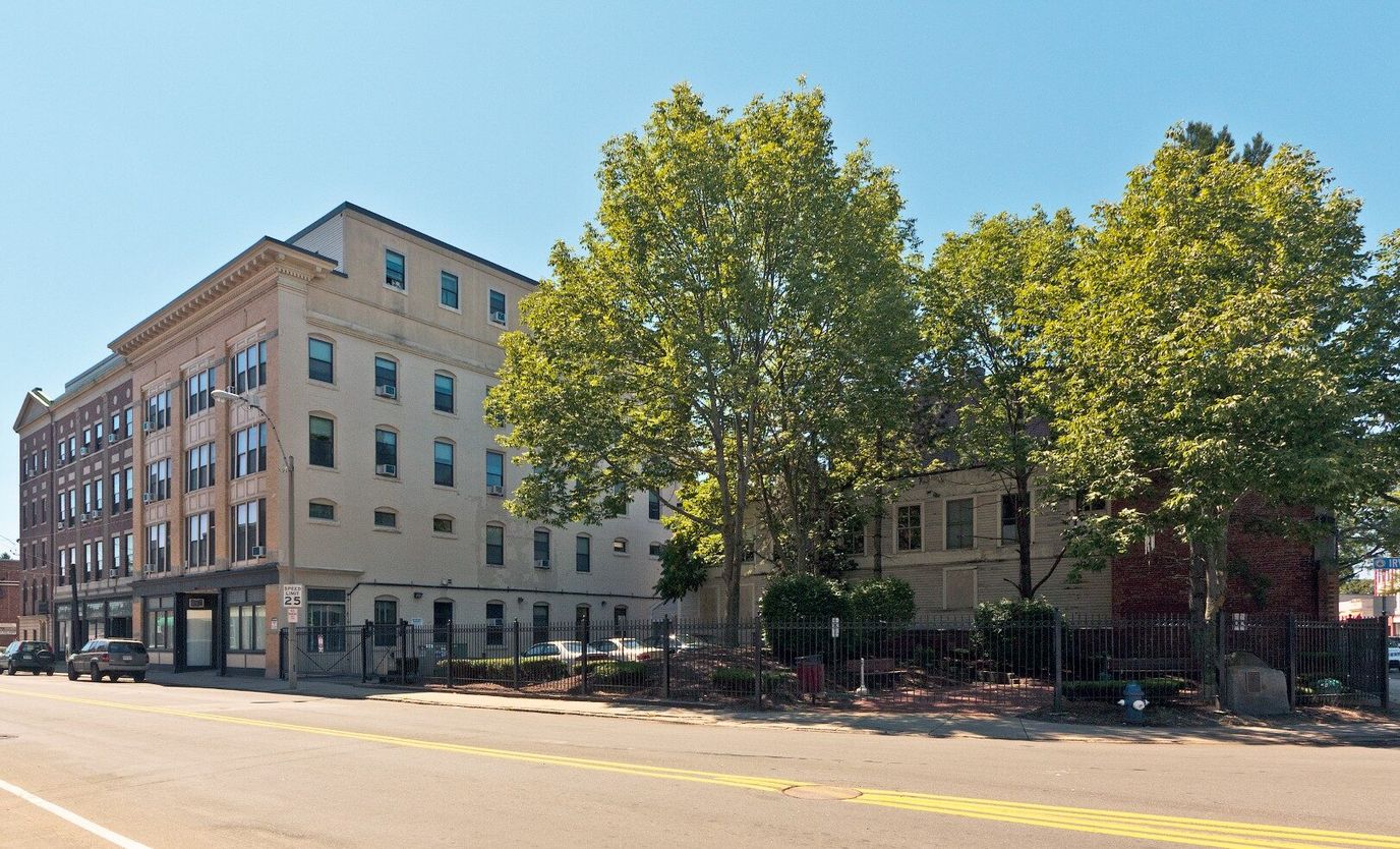 Exterior view of Irving Square Apartments with trees