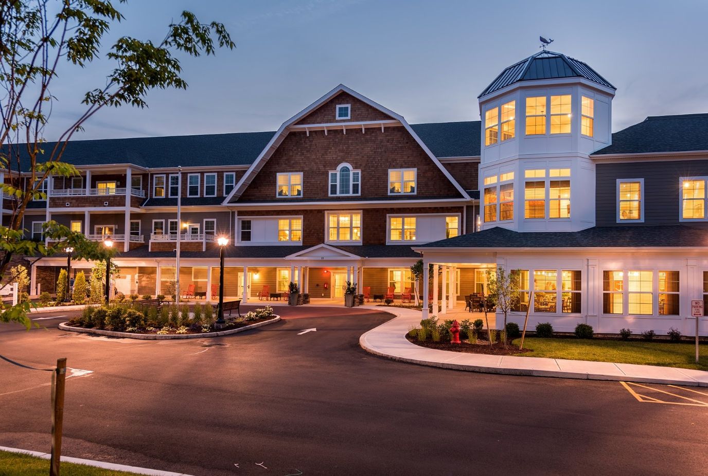 Exterior view of Laurelwood at The Pinehills at dusk