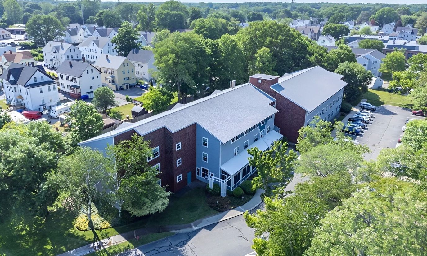 Aerial view of Mill Pond Apartments with surrounding trees