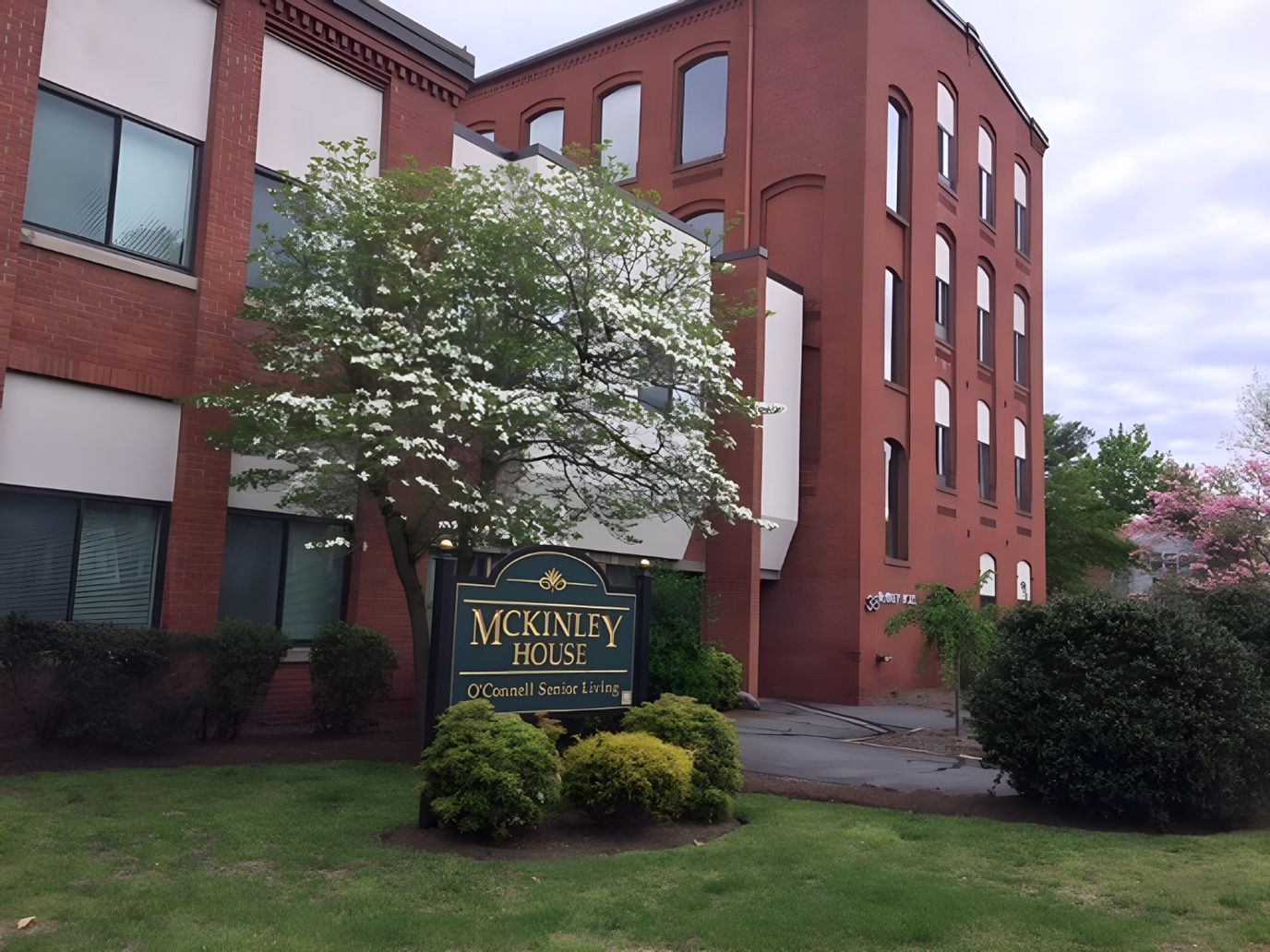 Exterior view of McKinley House with sign and greenery