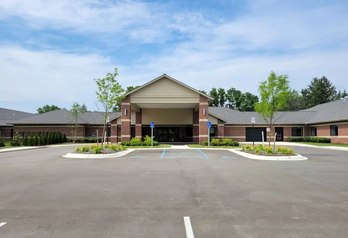 Exterior view of Hampton Manor building with parking