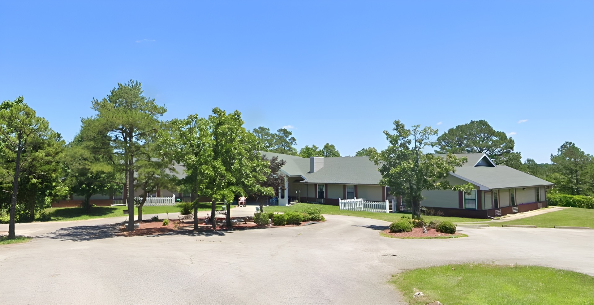 Exterior view of Holly House facility surrounded by trees