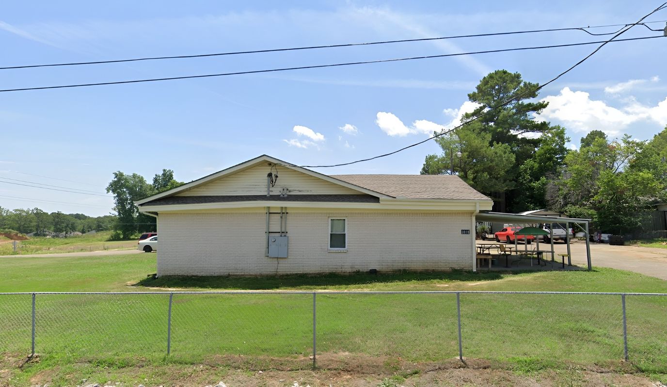 Exterior view of a small building with outdoor seating