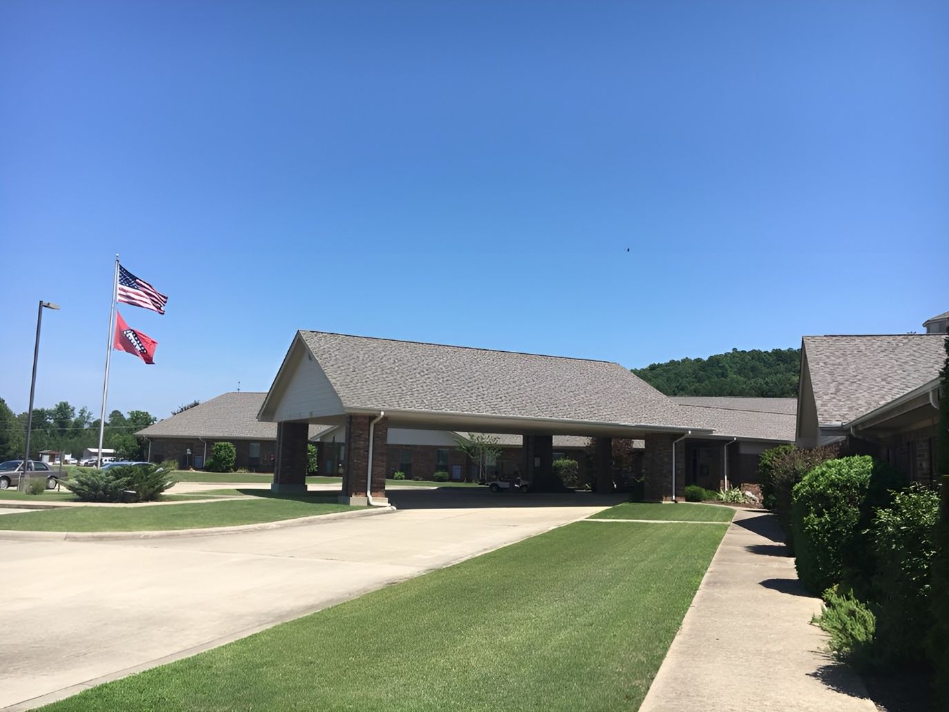 Exterior view of an assisted living facility with flags