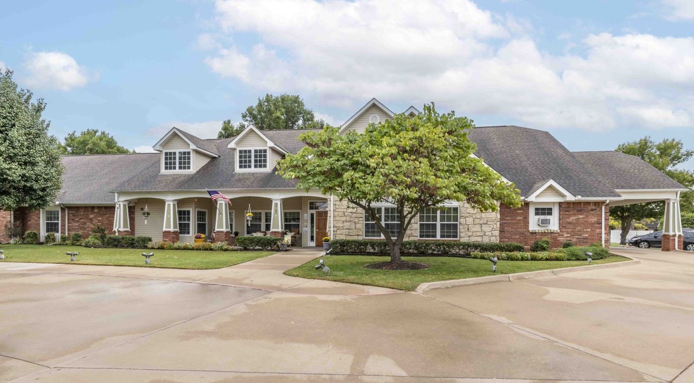 Exterior view of a senior living facility with landscaping