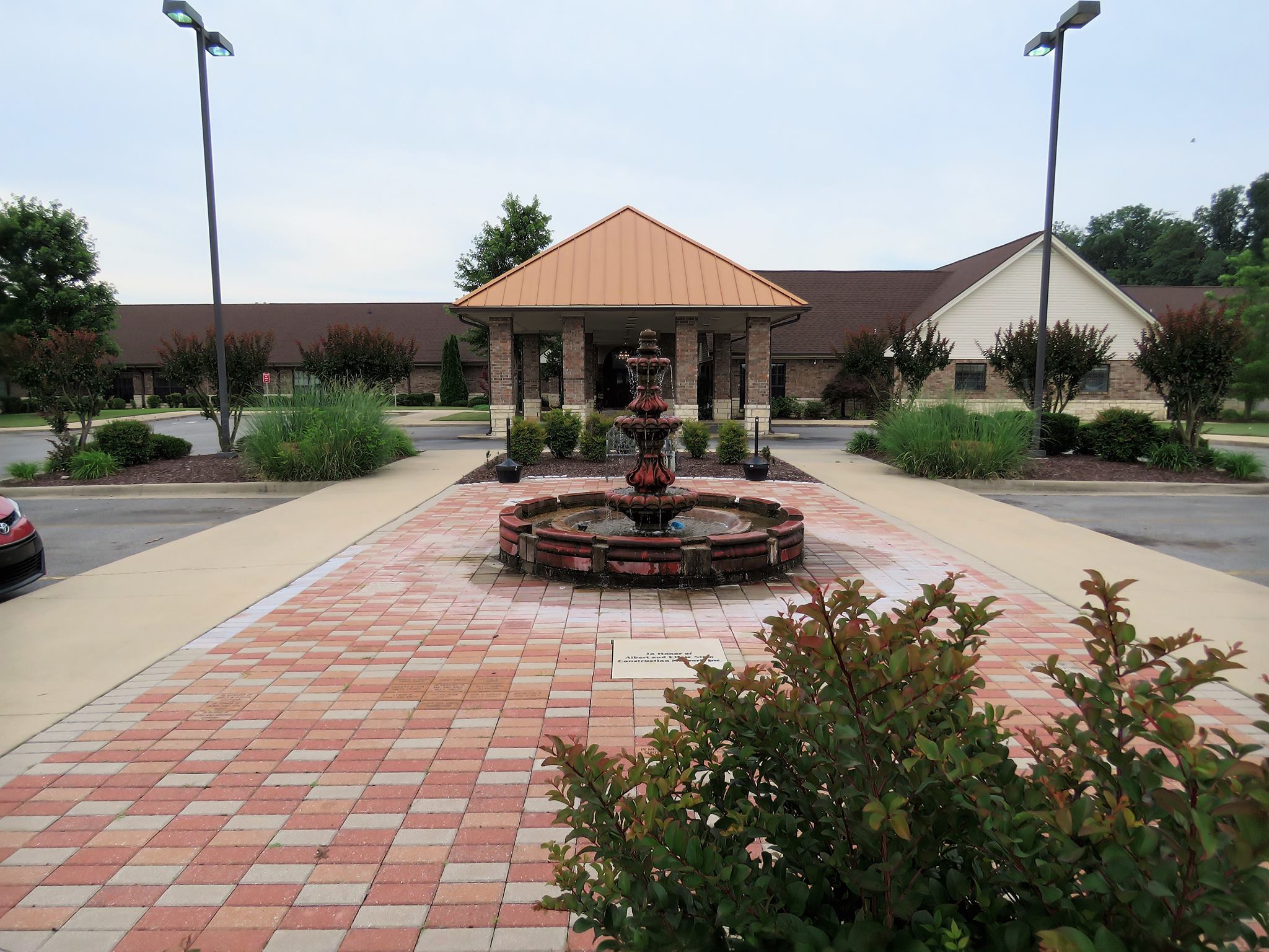 Exterior view of the facility entrance with fountain