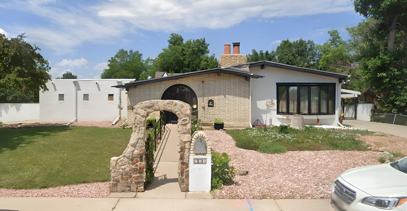 Exterior view of an assisted living facility with gardens