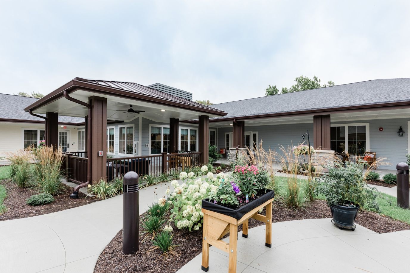 The entrance of Grand Brook Memory Care with landscaping