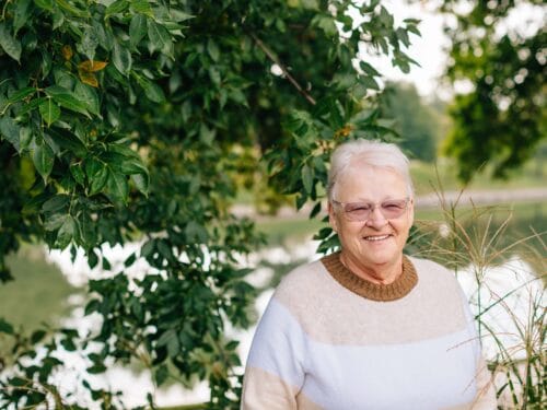 Smiling senior woman by a lake