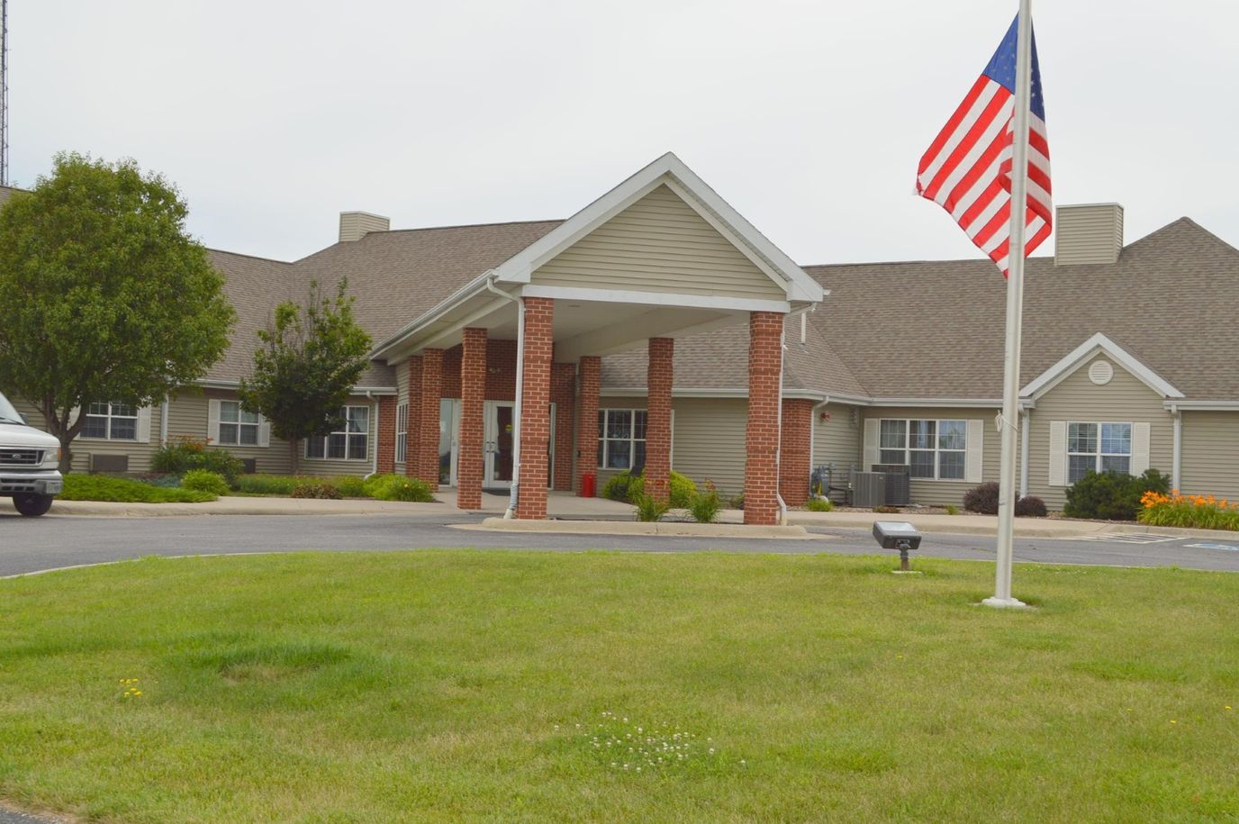Exterior view of Avoca Lodge with flag and landscaped area