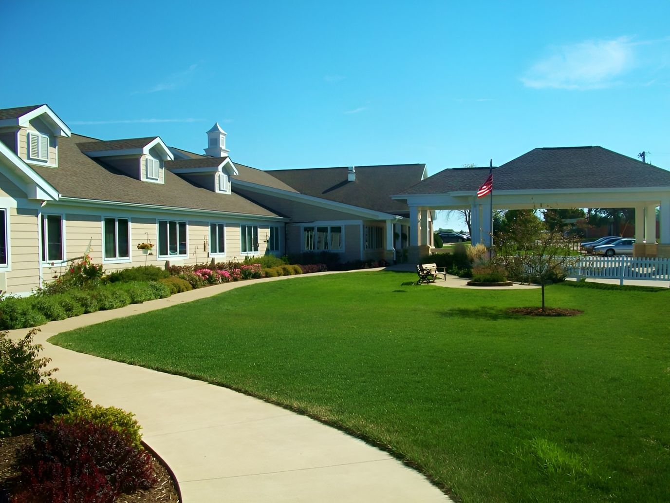 Exterior view of a senior living facility with landscaped grounds