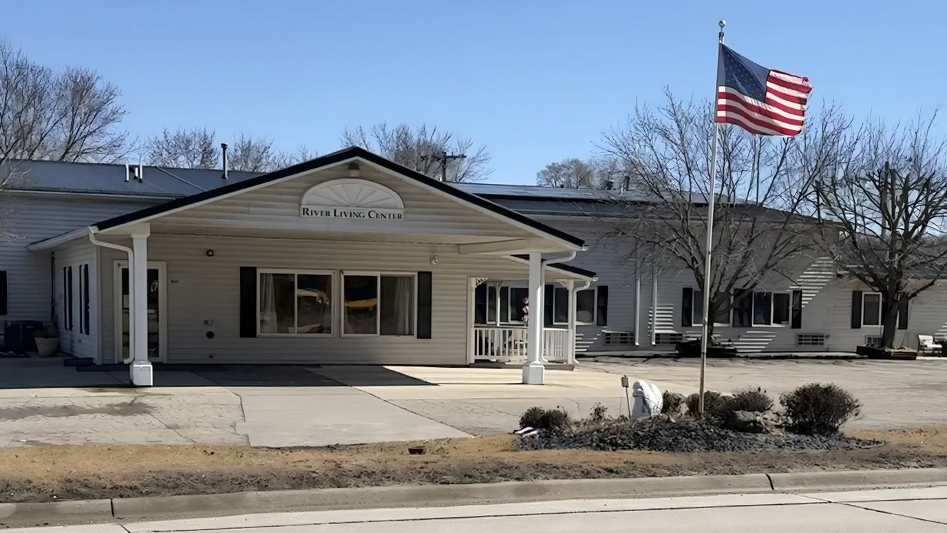 Exterior view of River Living Center with American flag