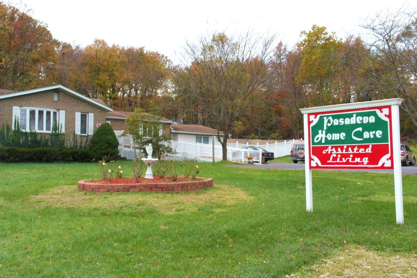 Exterior view of Pasadena Home Care with sign and garden