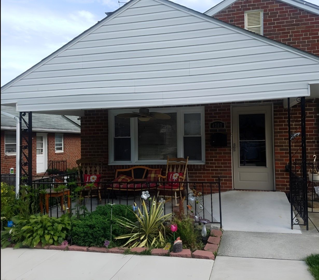 Exterior view of a porch with seating and garden