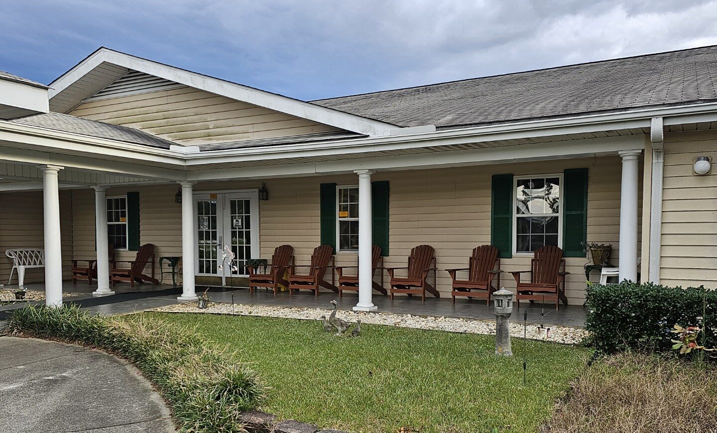 Exterior view of a senior living facility with seating area