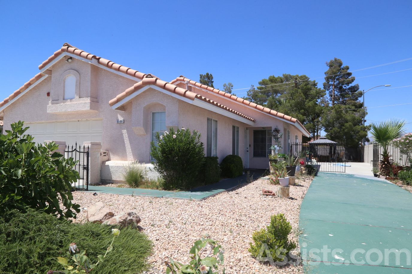 Carmela Homes, assisted living in Las Vegas, NV — Residential building with landscaped front yard and driveway
