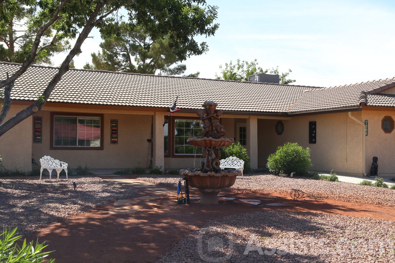 Exterior view of a senior care facility with a fountain