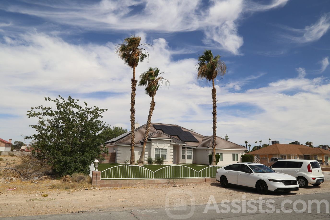 Exterior view of a residential home with palm trees