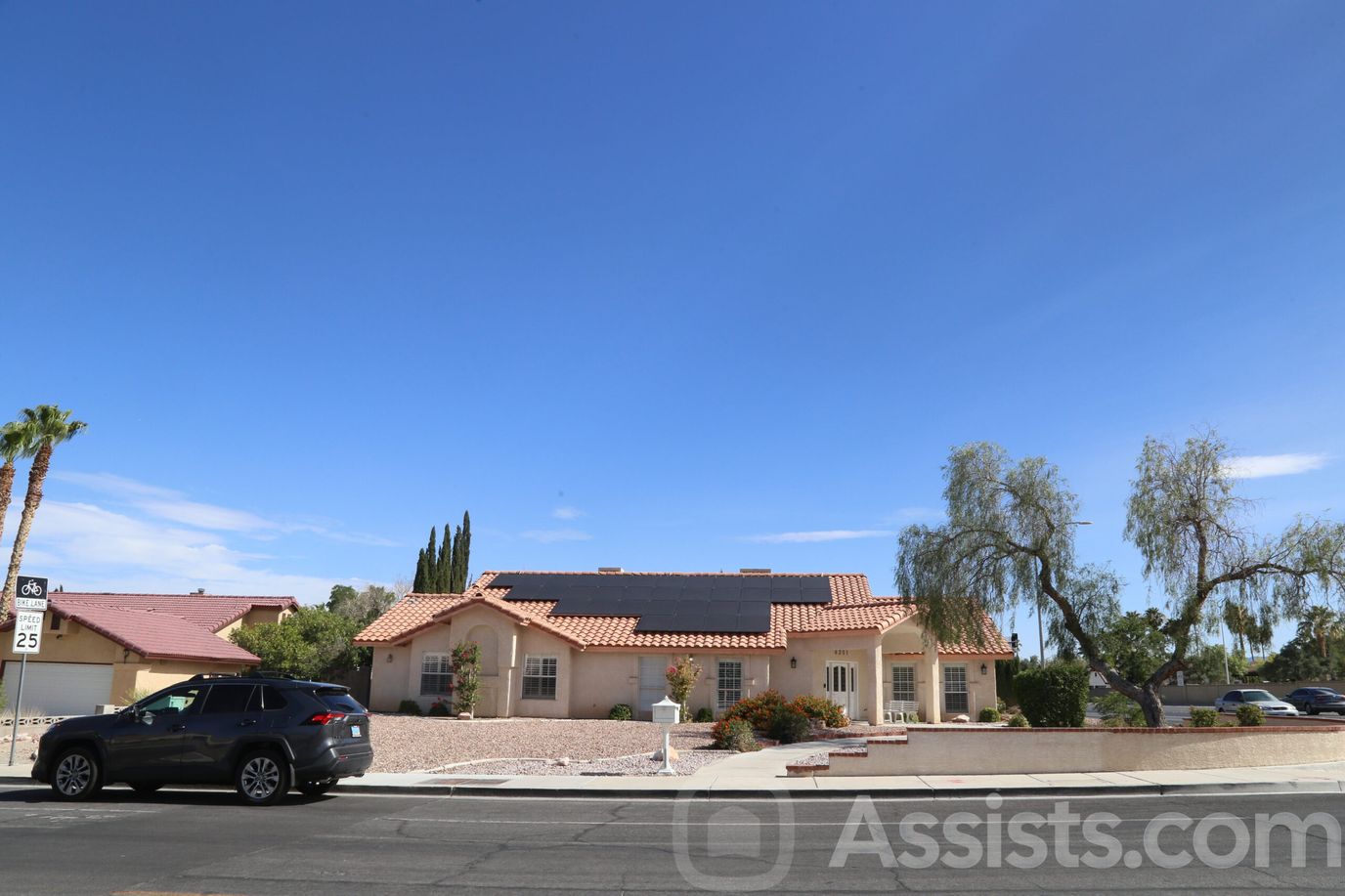 Exterior view of Palms Care Home with outdoor landscaping