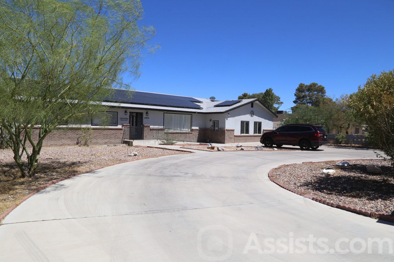 Exterior view of the facility with driveway and landscape