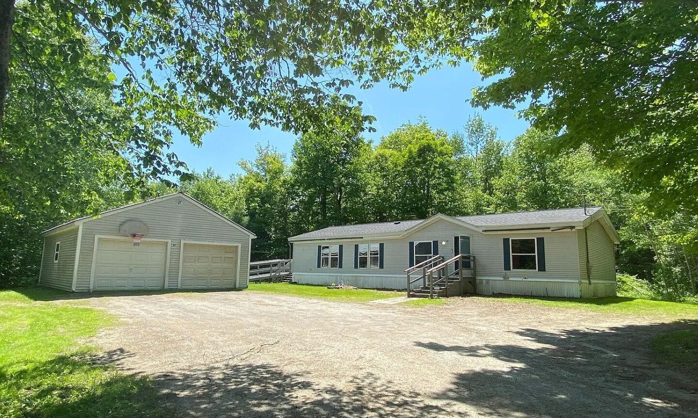 Exterior view of a single-story building surrounded by trees