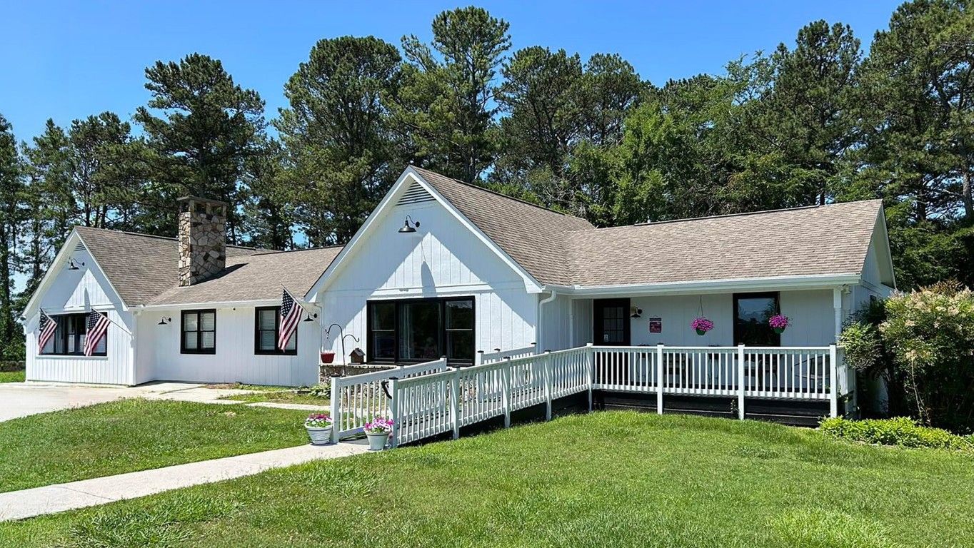 Exterior view of a senior care home with a garden