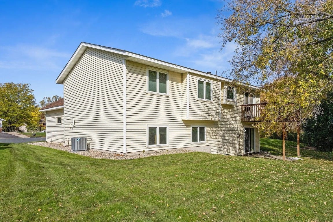 Exterior view of a senior living building with grassy area