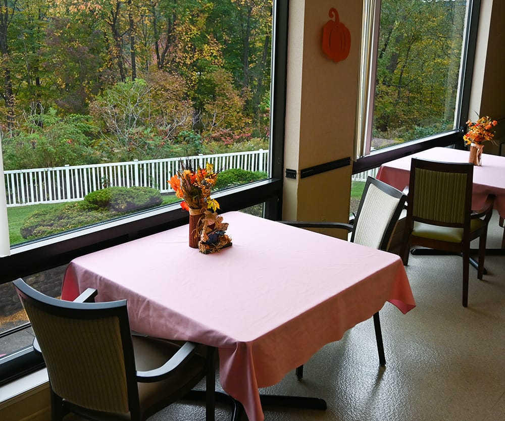 Dining area with tables set for residents